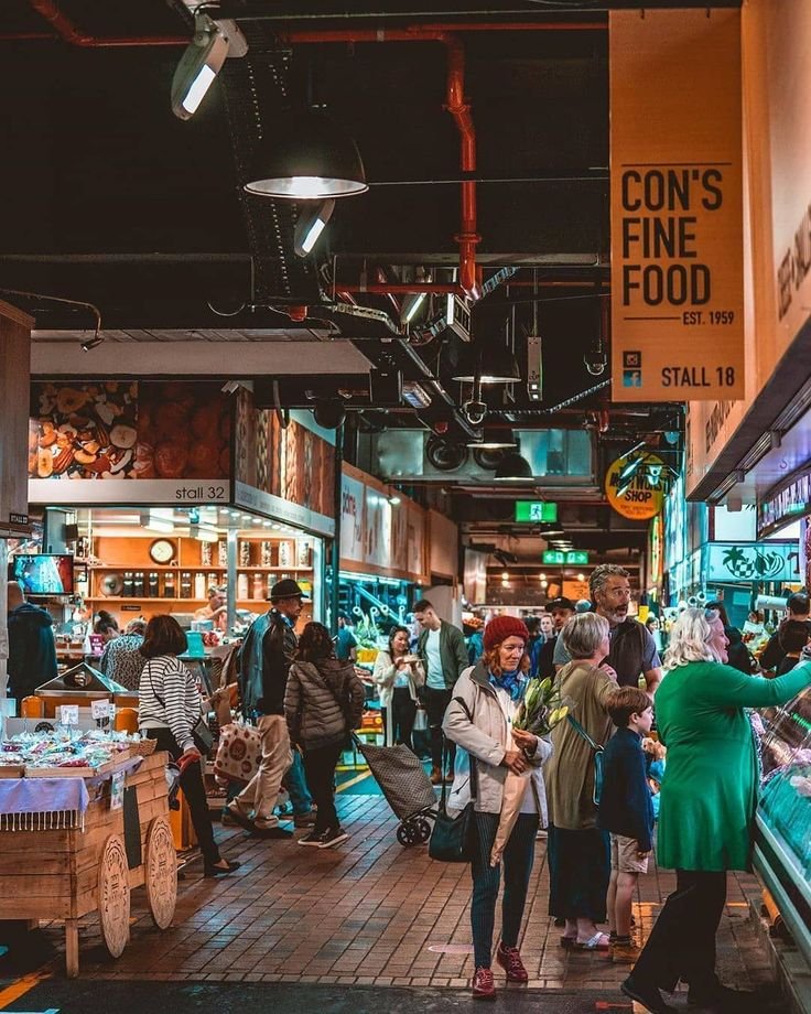 This may contain: many people are shopping in an indoor market