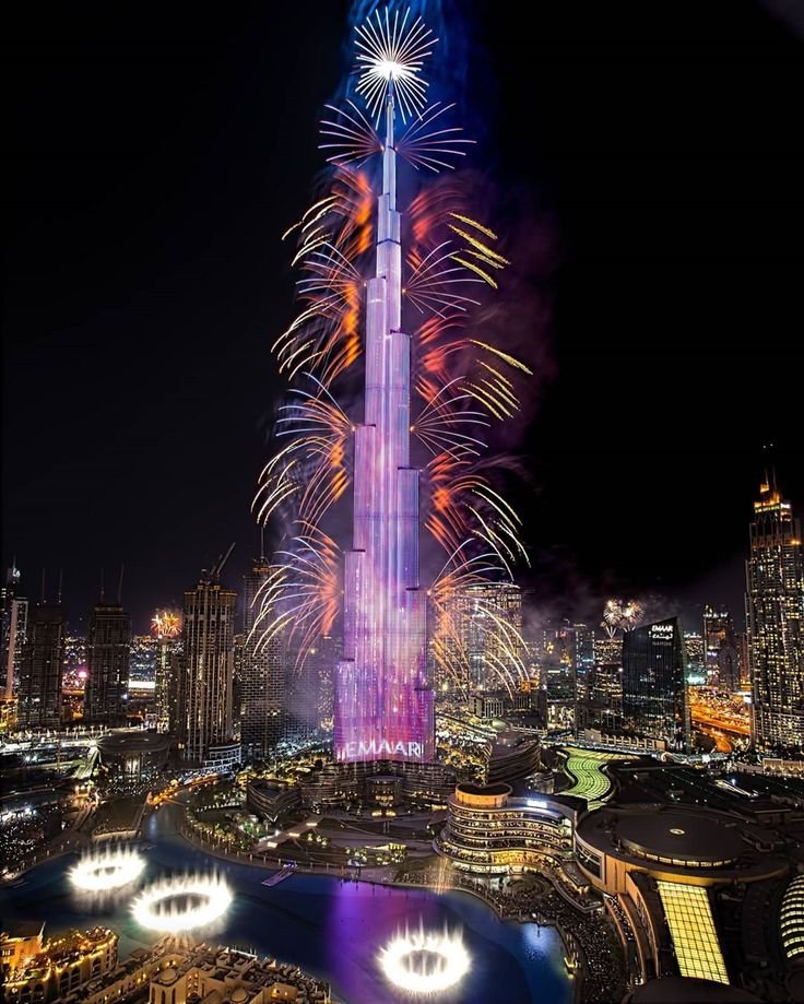 This may contain: fireworks light up the night sky above skyscrapers