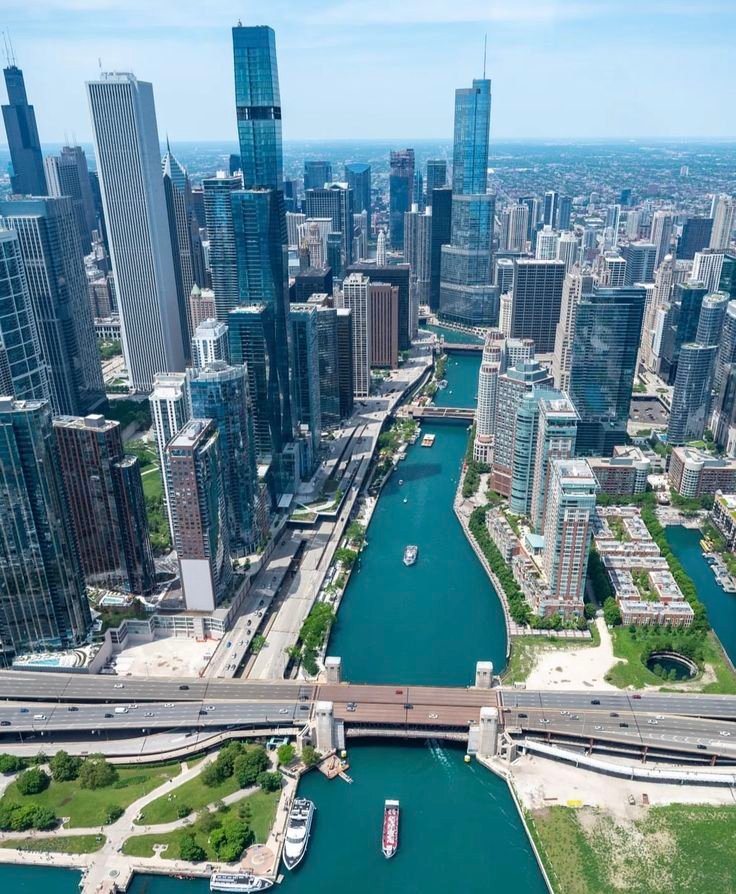 This may contain: an aerial view of the chicago river and downtown