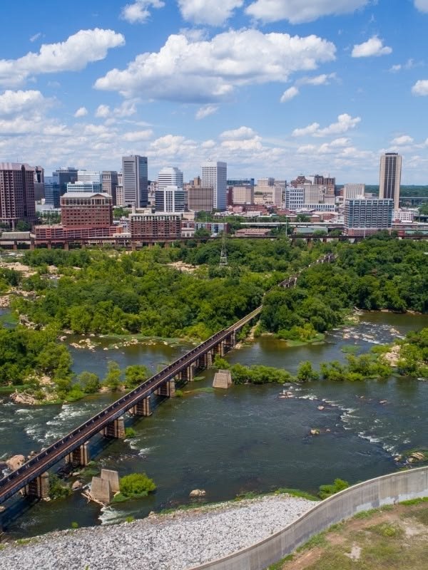 This may contain: an aerial view of a river and bridge in the city