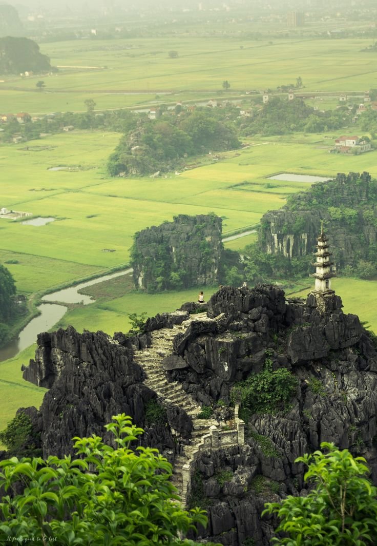 This may contain: an aerial view of a mountain with green fields in the background