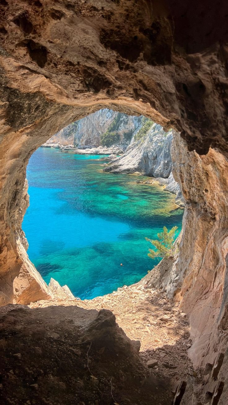 This may contain: the water is blue and clear in this cave