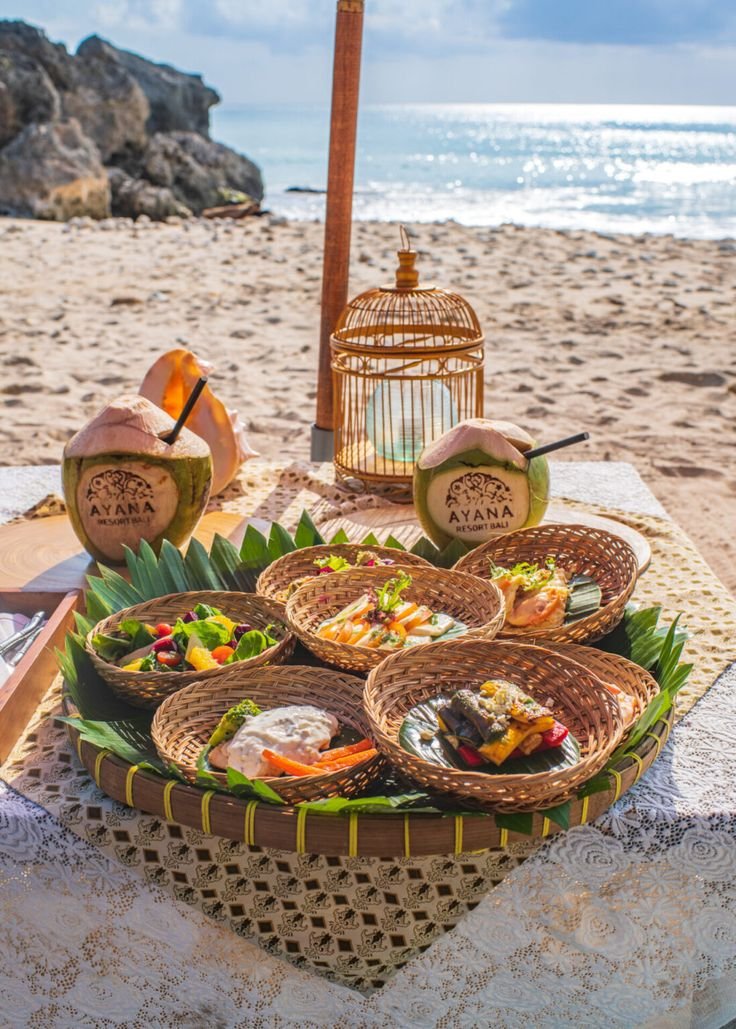 This may contain: an assortment of food on a table at the beach