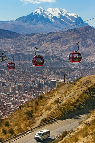 This may contain: the cable cars are going up and down the hill to get to the mountain top