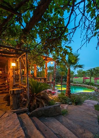 This may contain: an outdoor patio with steps leading up to the pool