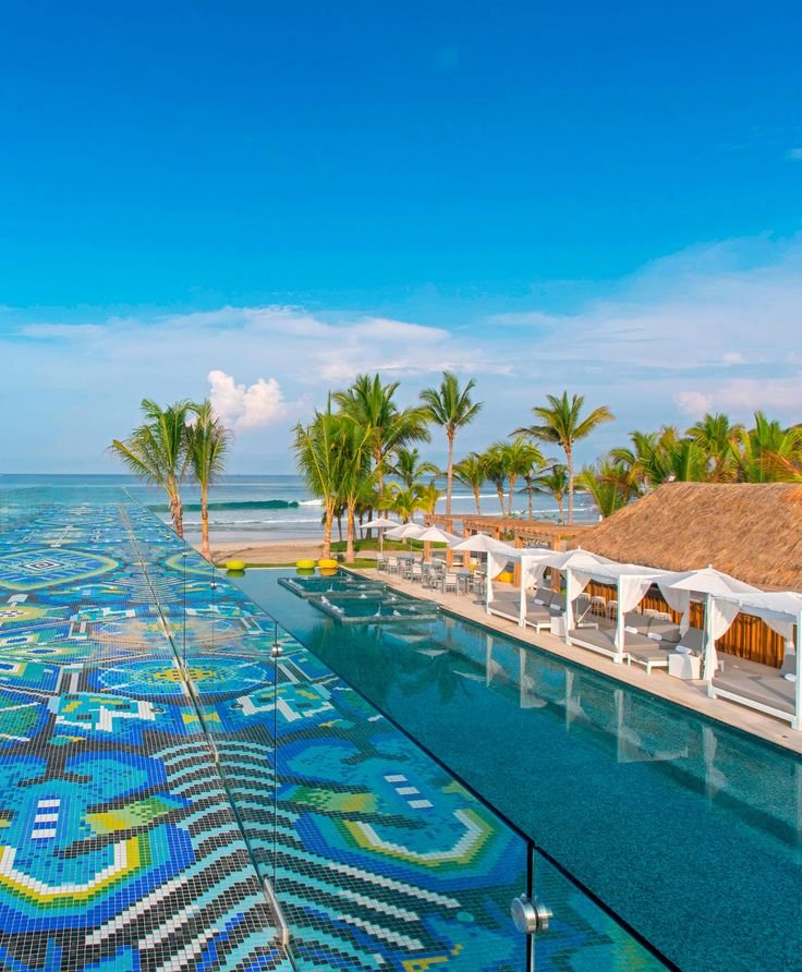 This may contain: an outdoor swimming pool surrounded by palm trees