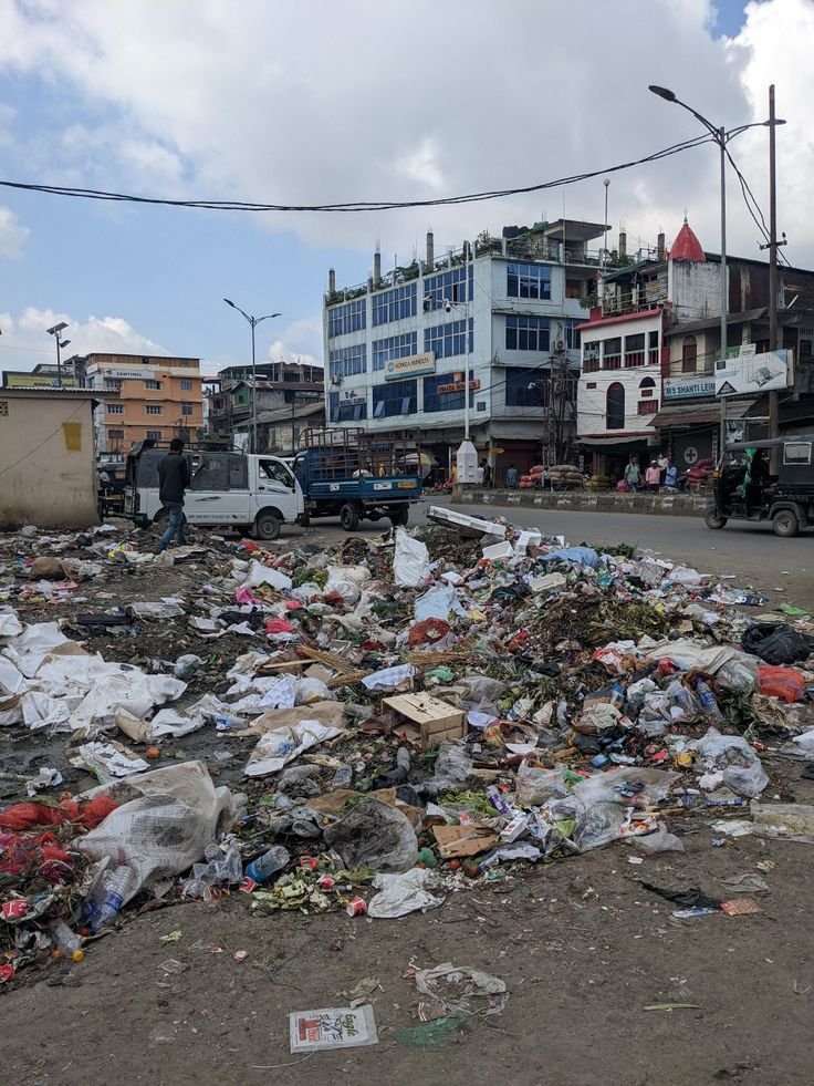 This may contain: trash on the ground in front of some buildings