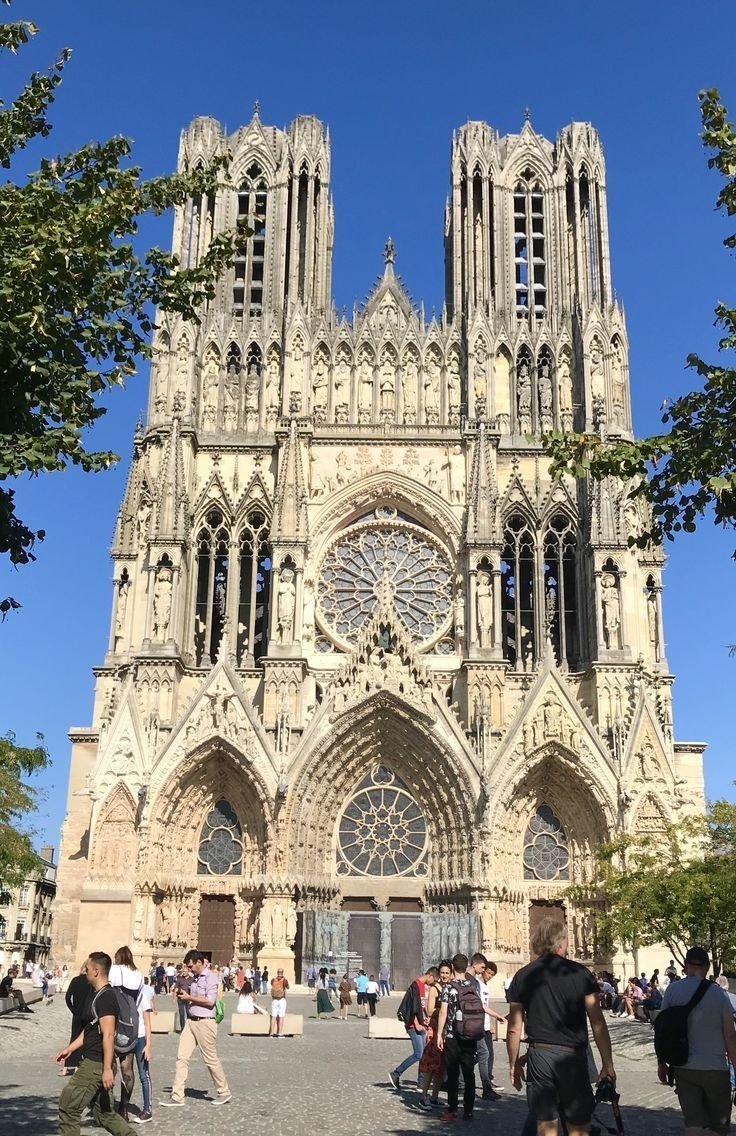 This may contain: people are walking around in front of a large cathedral
