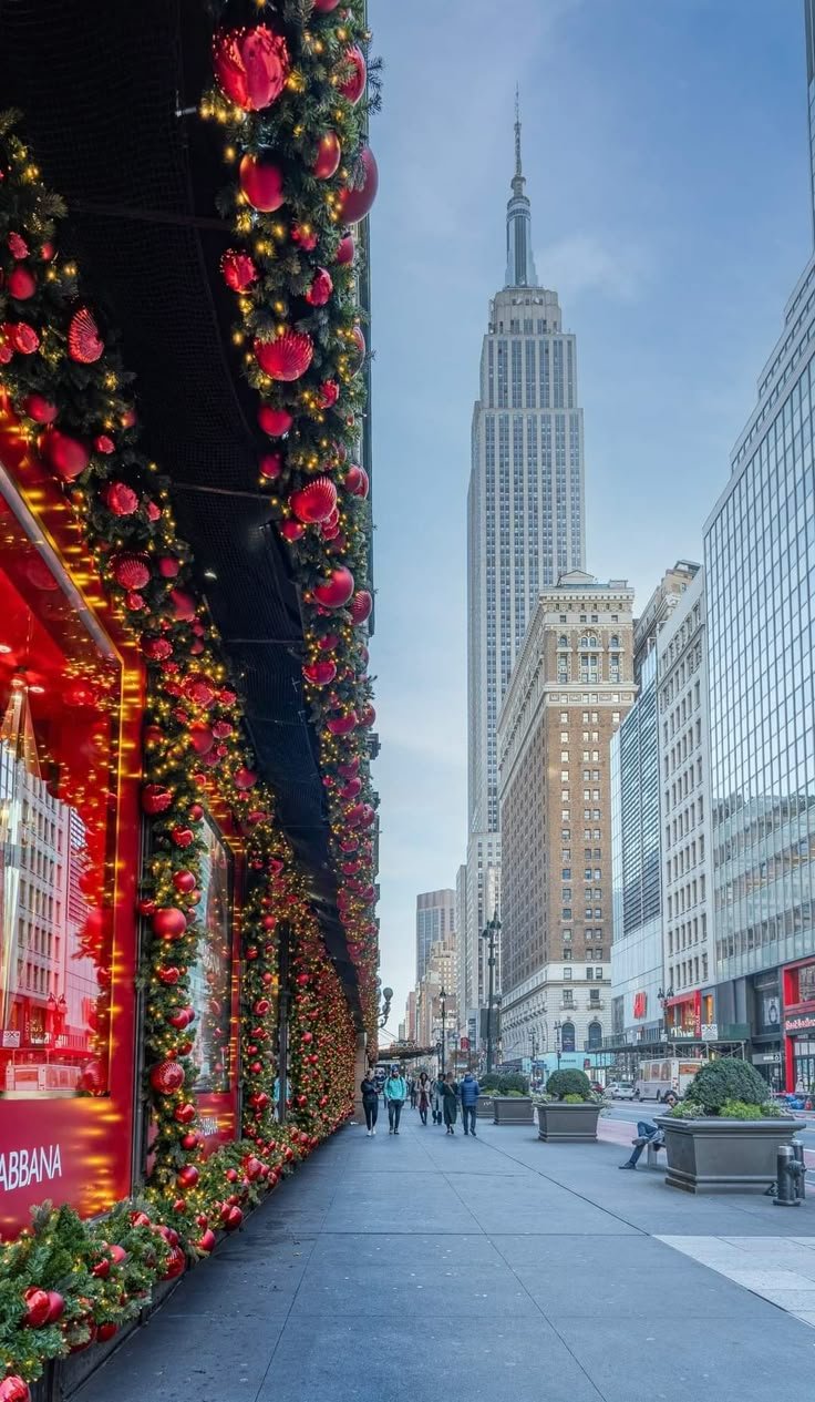 This may contain: christmas decorations adorn the side of buildings in new york city