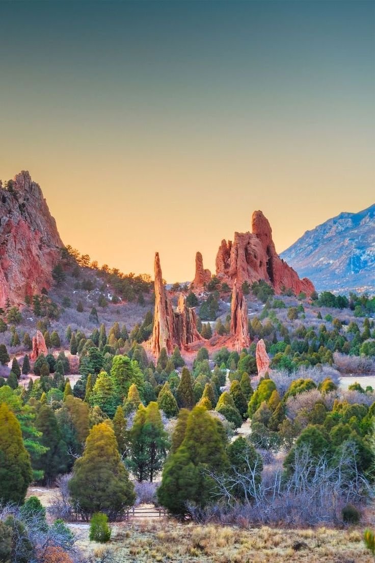 This may contain: the sun is setting over garden of the gods