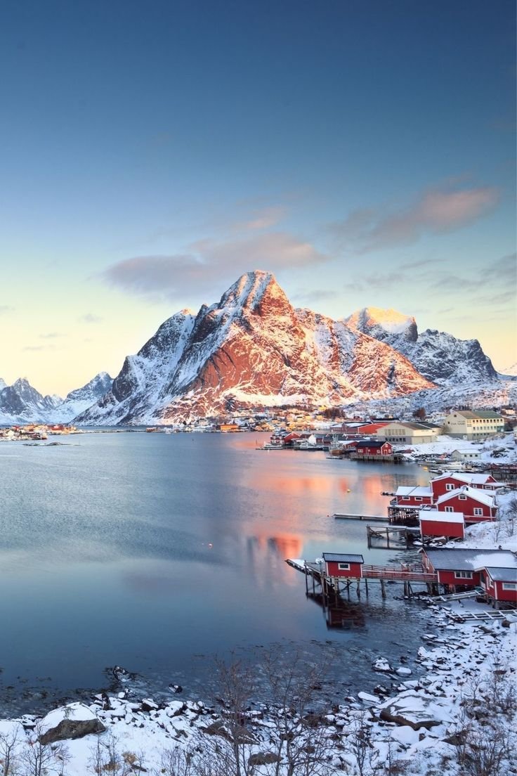 This may contain: the mountains are covered in snow and some water