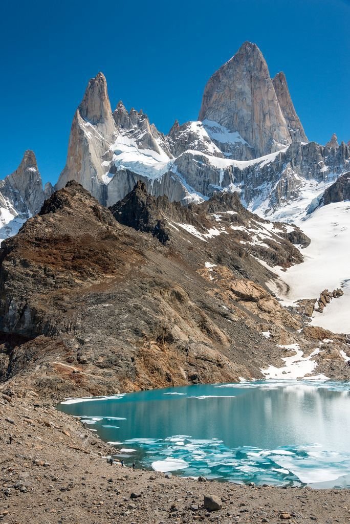 This may contain: the mountains are covered in snow and ice