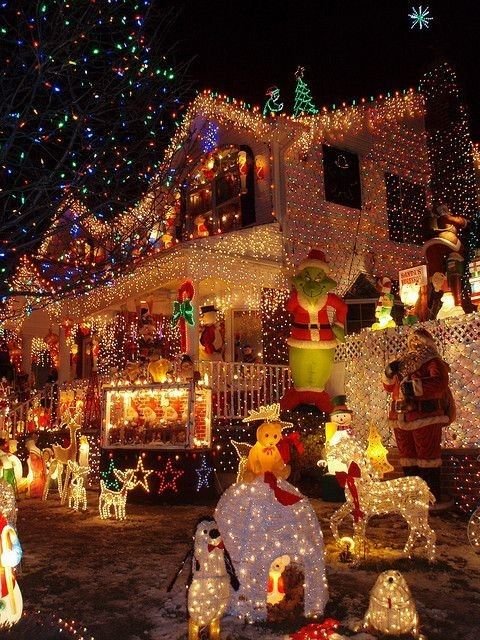 This may contain: a house covered in christmas lights and decorations