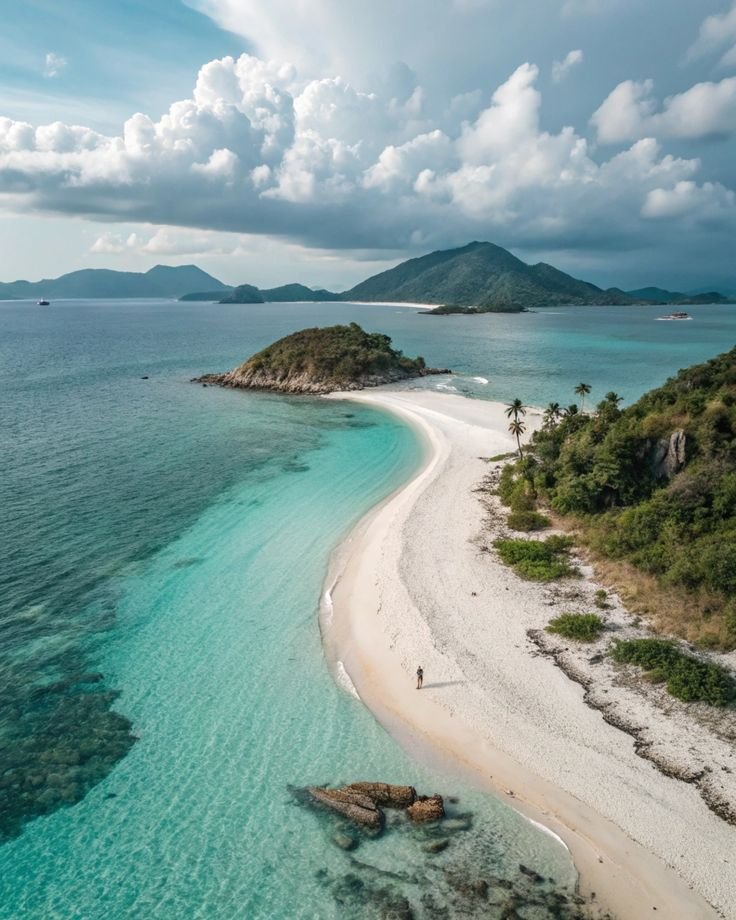 This may contain: an aerial view of the beach and lagoons in front of some tropical island formations