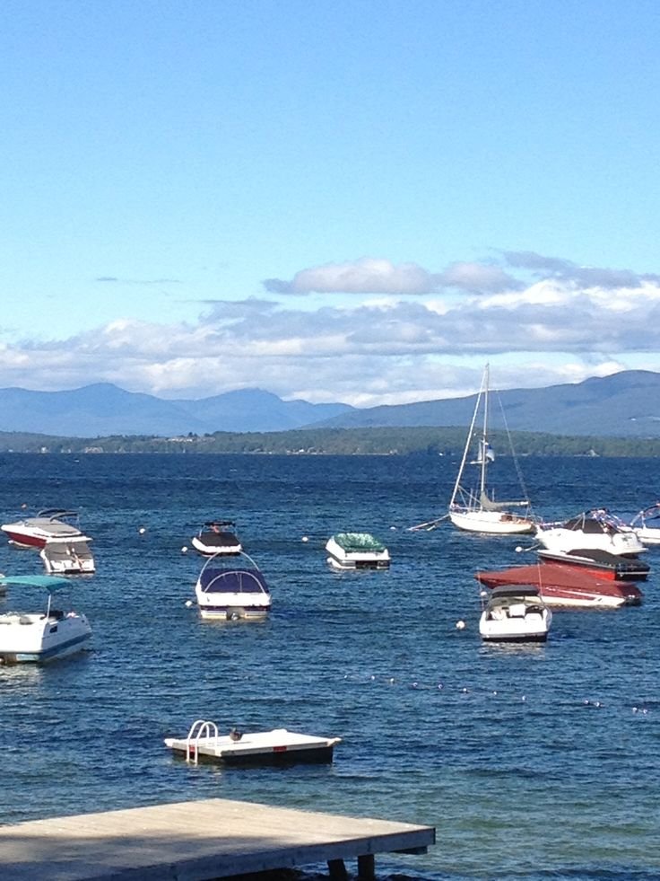 This may contain: several boats floating in the water on a sunny day