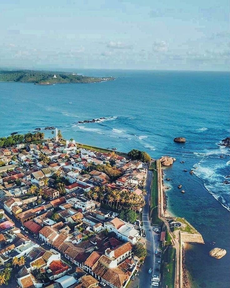 This may contain: an aerial view of a city next to the ocean