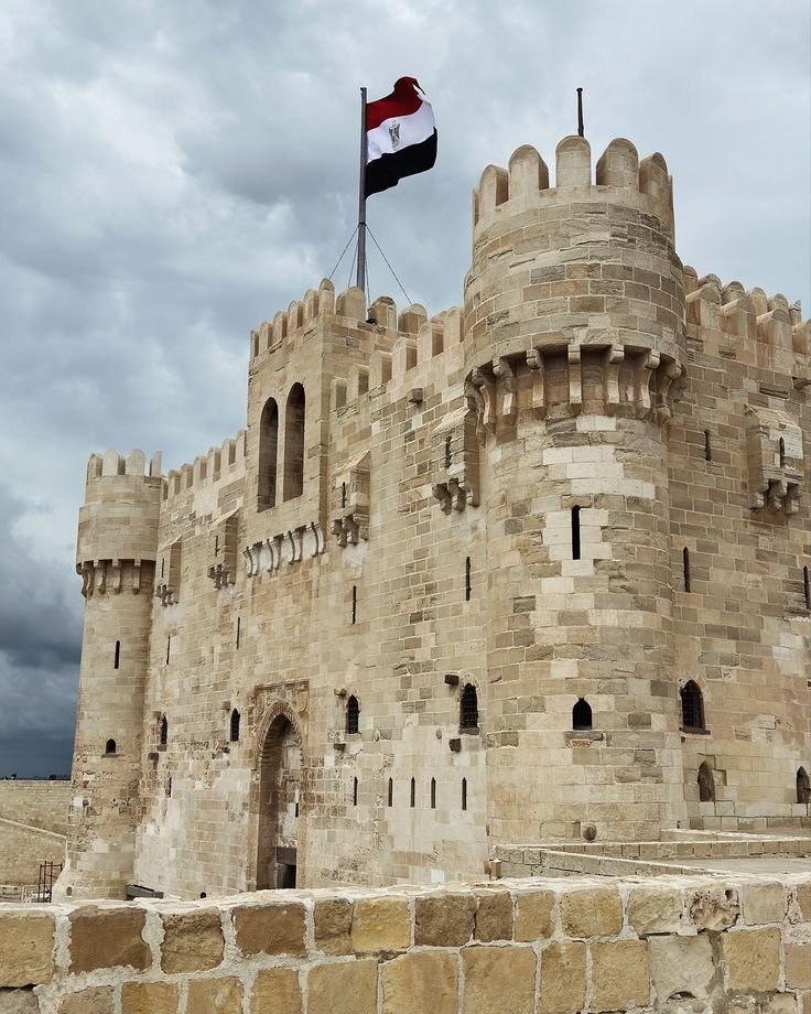 This may contain: an old stone castle with a flag on top
