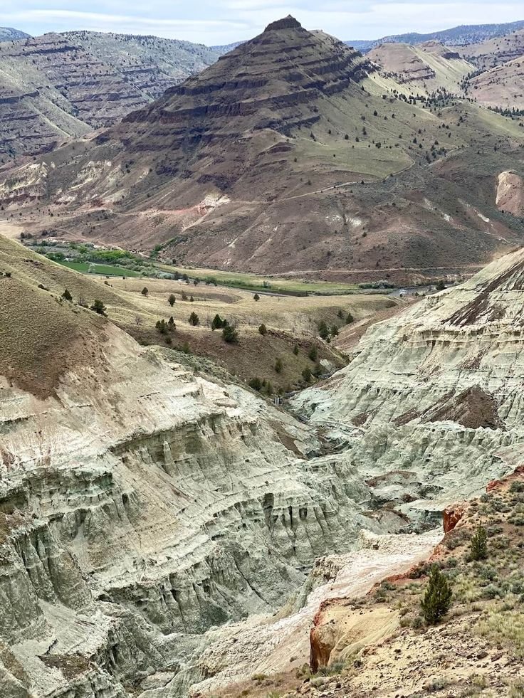 This may contain: the mountains are filled with different colored rocks