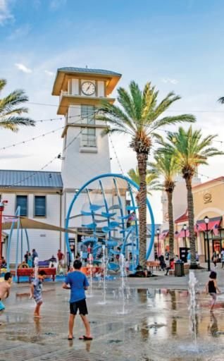 This may contain: children playing in the water at an amusement park