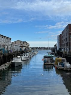 This may contain: there are many boats that are docked in the water