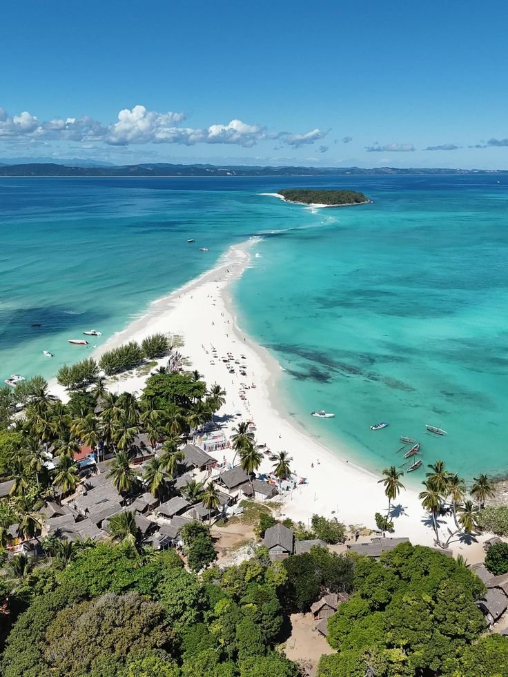 This may contain: an aerial view of the beach and lagoons in fiji, with palm trees on either side
