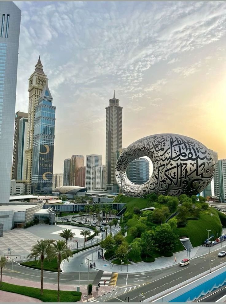 This may contain: an artistic view of a city with tall buildings in the background and a giant fish sculpture on top