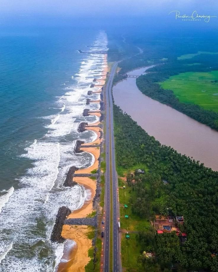 This may contain: an aerial view of the ocean and beach with cars driving on it's side