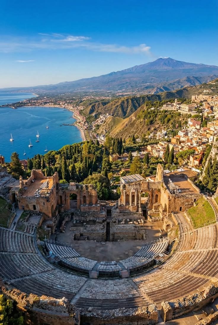 This may contain: an aerial view of the roman amphits in taolo, italy with mountains in the background