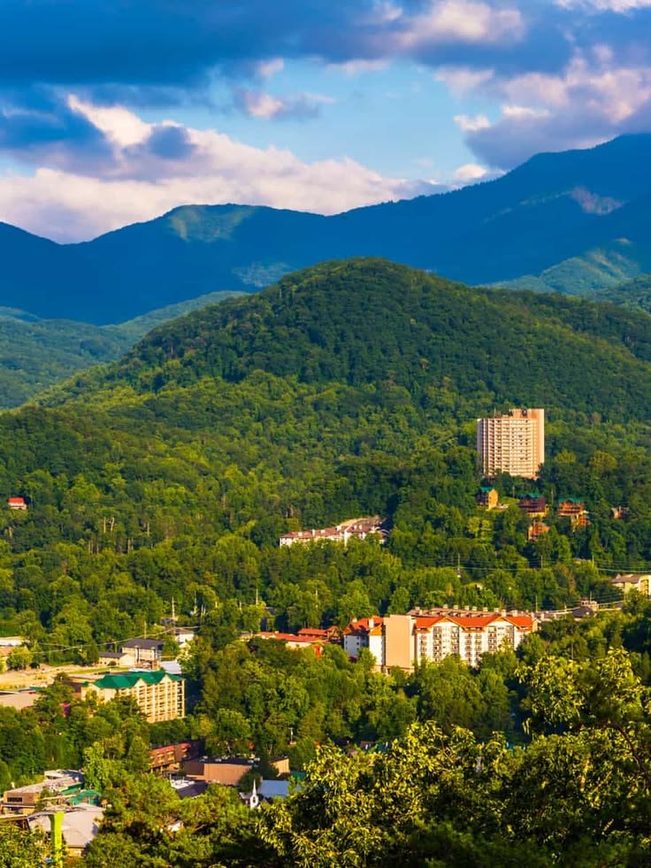 This contains: Sunrise Views in the Great Smoky Mountains: A Stunning Overlook of Gatlinburg