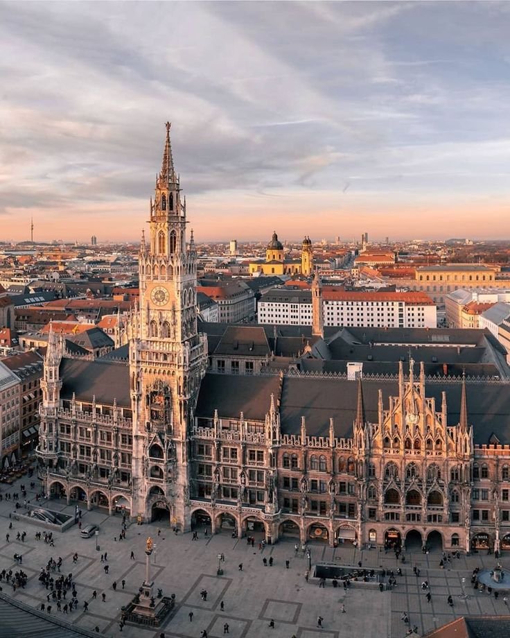 This may contain: an aerial view of a large building with many spires in the center and people walking around it