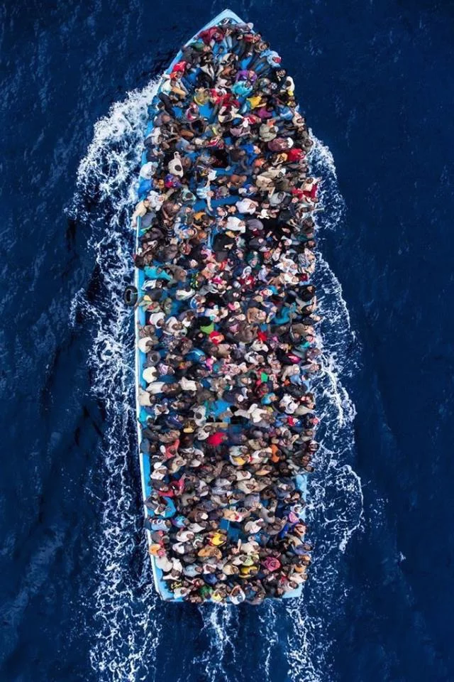 This may contain: a boat full of people in the water with their backs turned to look like they are floating