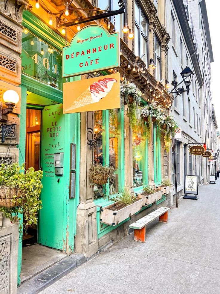 This may contain: the outside of a restaurant with green doors and plants growing out of it's windows