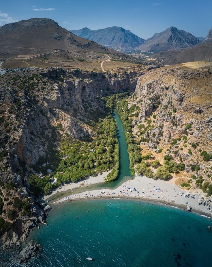 This may contain: an aerial view of a river running through the mountains