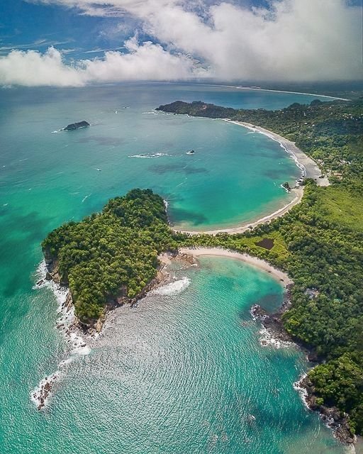 This may contain: an island surrounded by water and trees