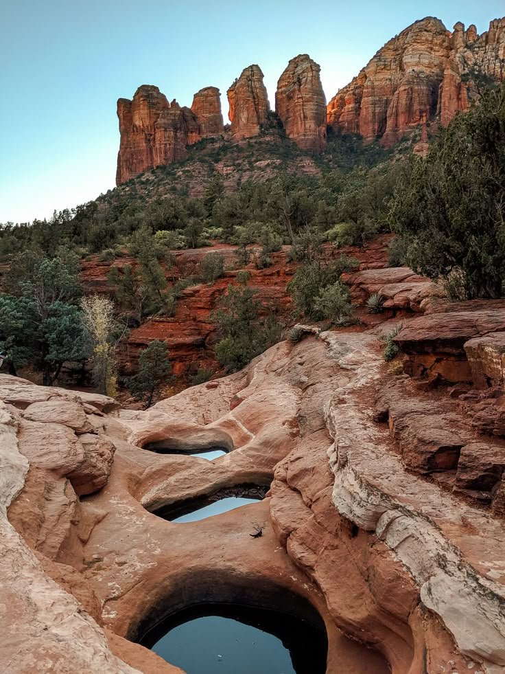 This may contain: there is a hole in the rock with water