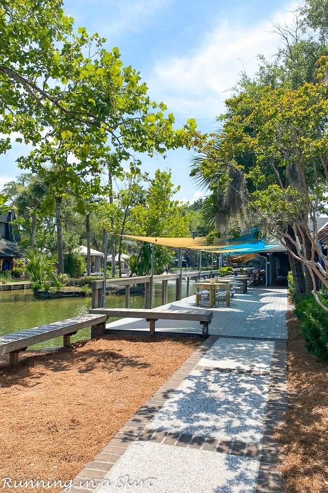 This may contain: the walkway is lined with benches and trees