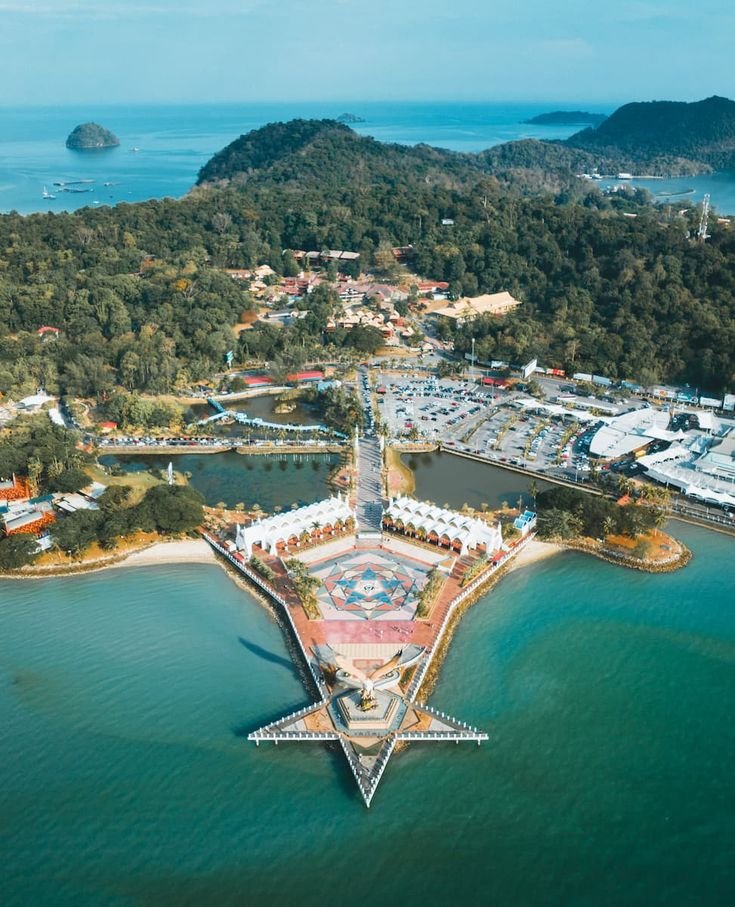 This may contain: an aerial view of the marina and surrounding area with boats in the water, surrounded by trees