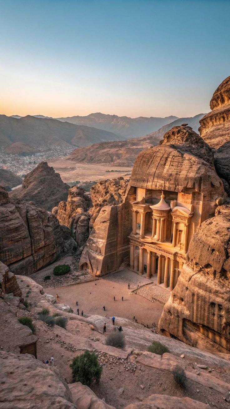 This may contain: an ancient building in the middle of some rocks and mountains with people walking around it