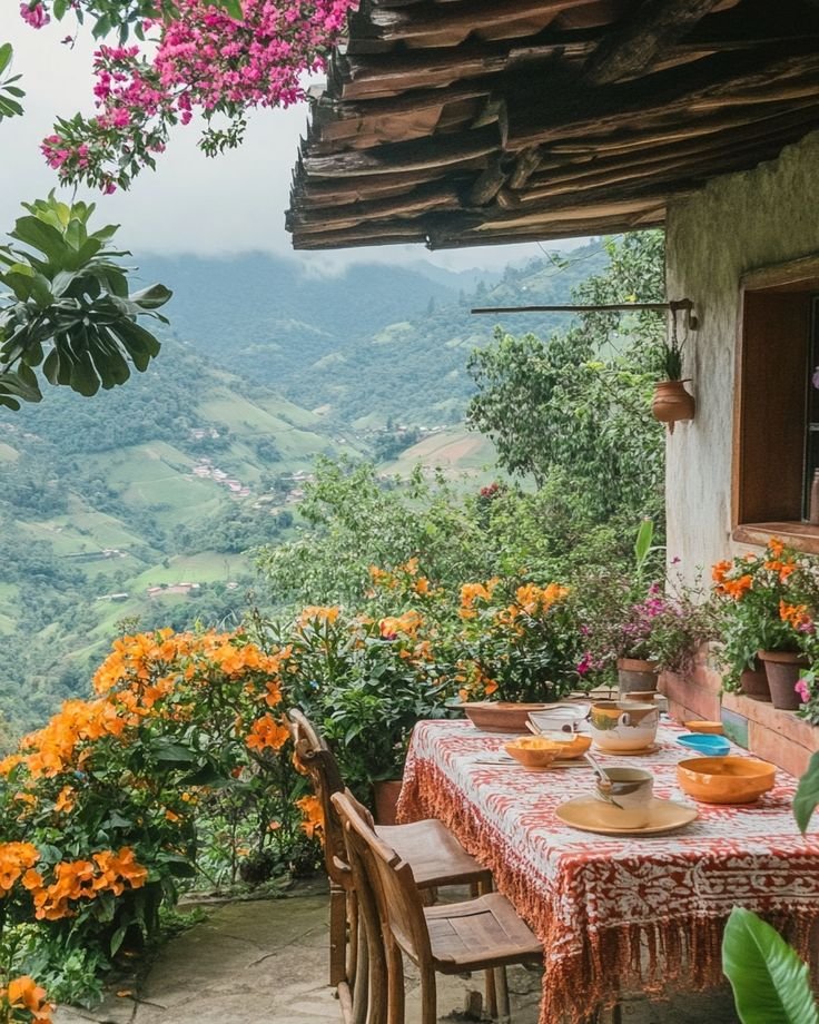 This may contain: a table with plates and bowls on it in front of a window overlooking the mountains
