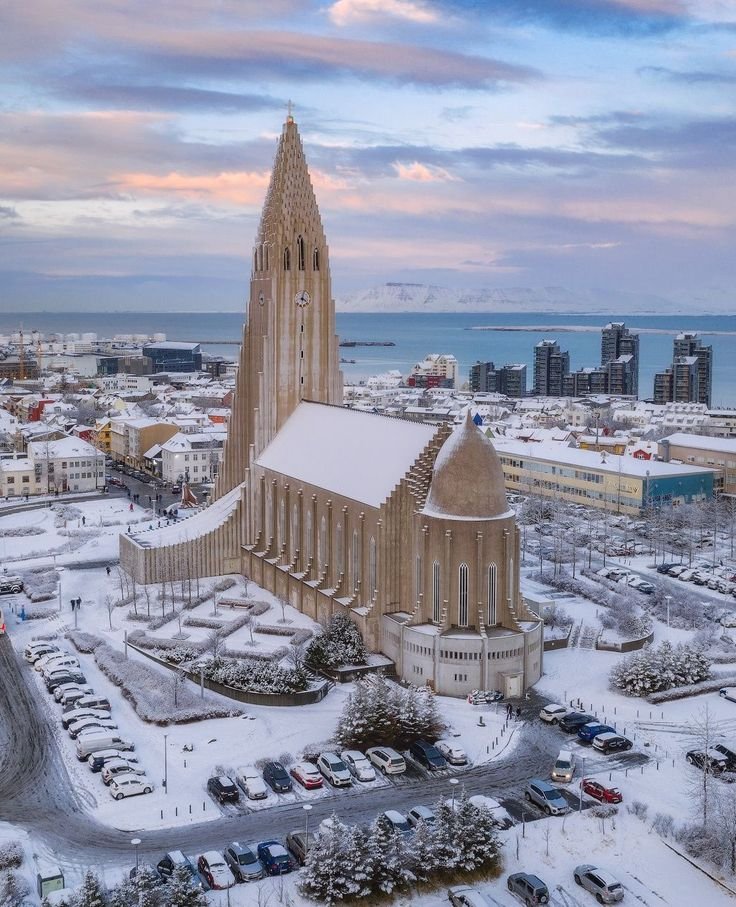 This may contain: an aerial view of a large church in the middle of winter with snow on the ground