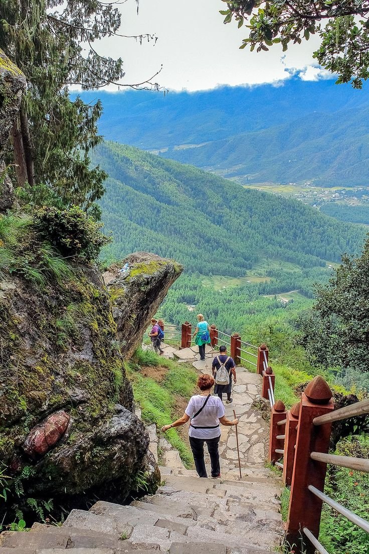 This may contain: people walking up stairs in the mountains with backpacks