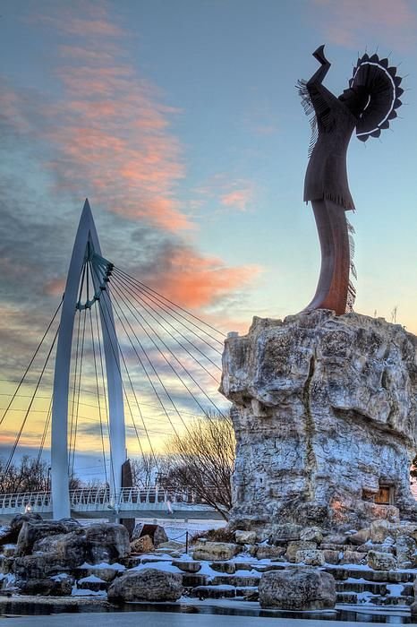 This may contain: the statue is in front of a beautiful sunset