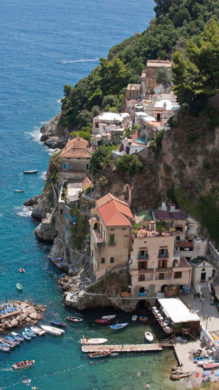 This may contain: an aerial view of a small village on the edge of a cliff
