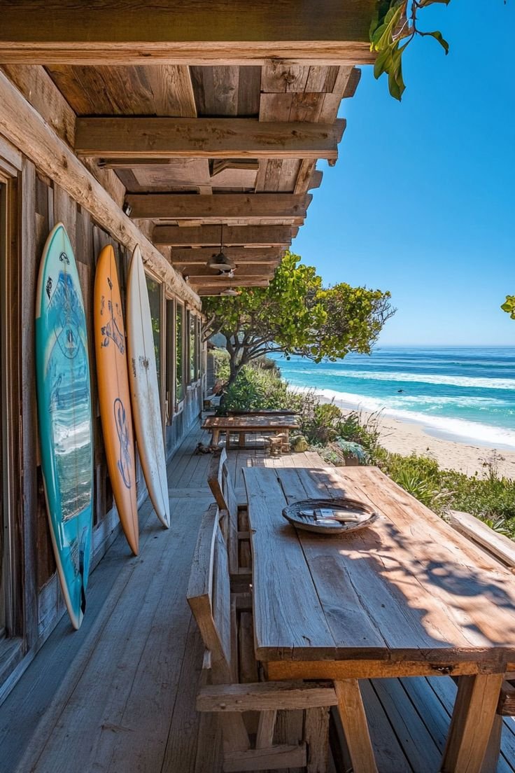 This may contain: there are many surfboards on the outside of this house by the beach and ocean