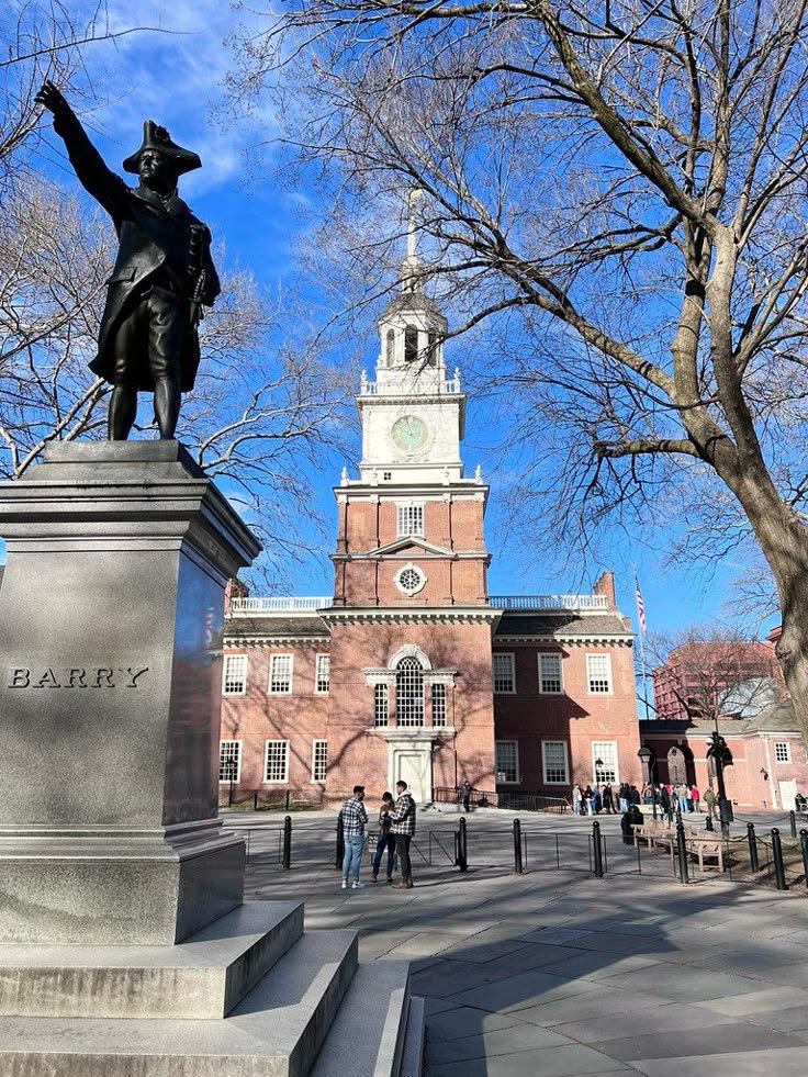 This may contain: a statue in front of a building with a clock tower