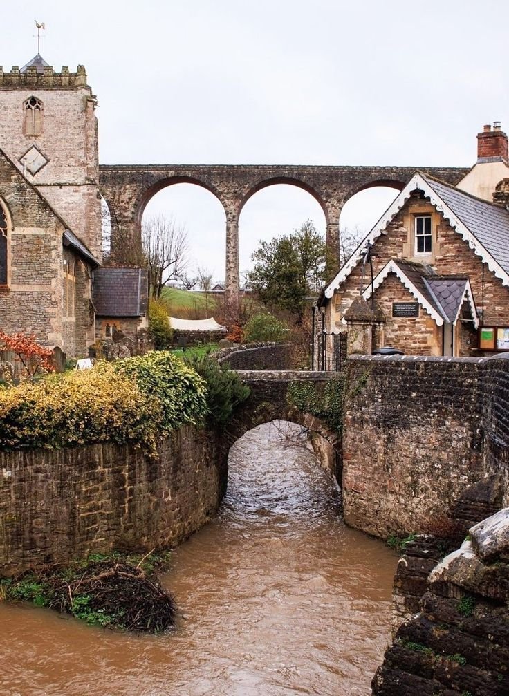 This may contain: an old stone bridge over a muddy river