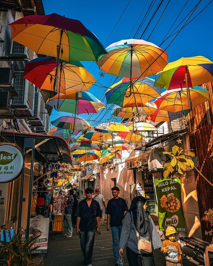 This may contain: people walking down an alley with umbrellas overhead