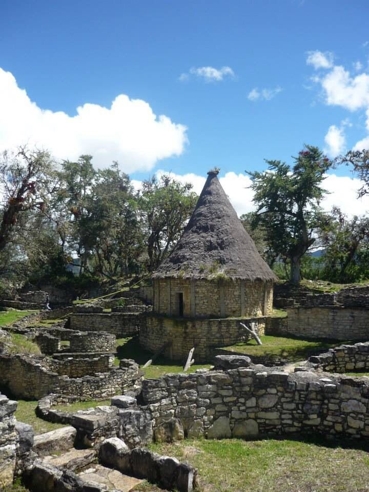 This may contain: an old stone building with a thatched roof