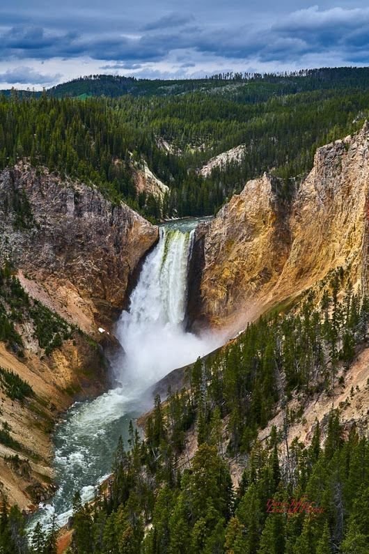 This may contain: an aerial view of a waterfall in the mountains