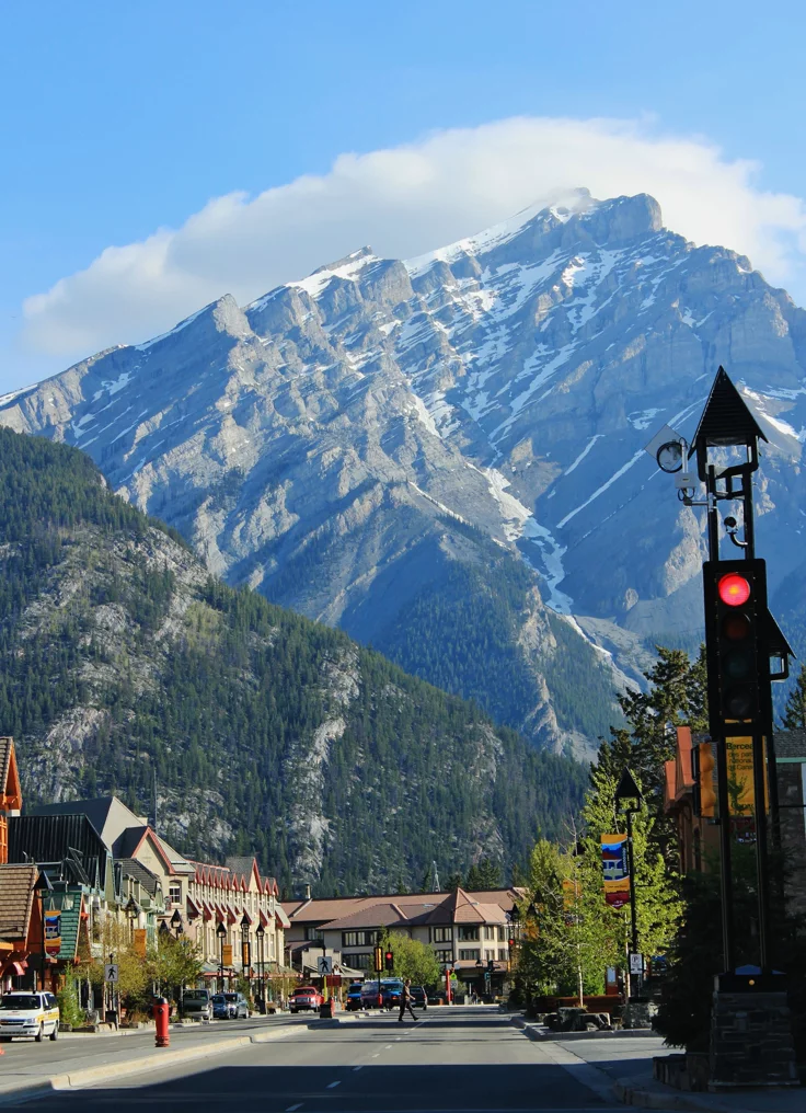 This may contain: a town with mountains in the background